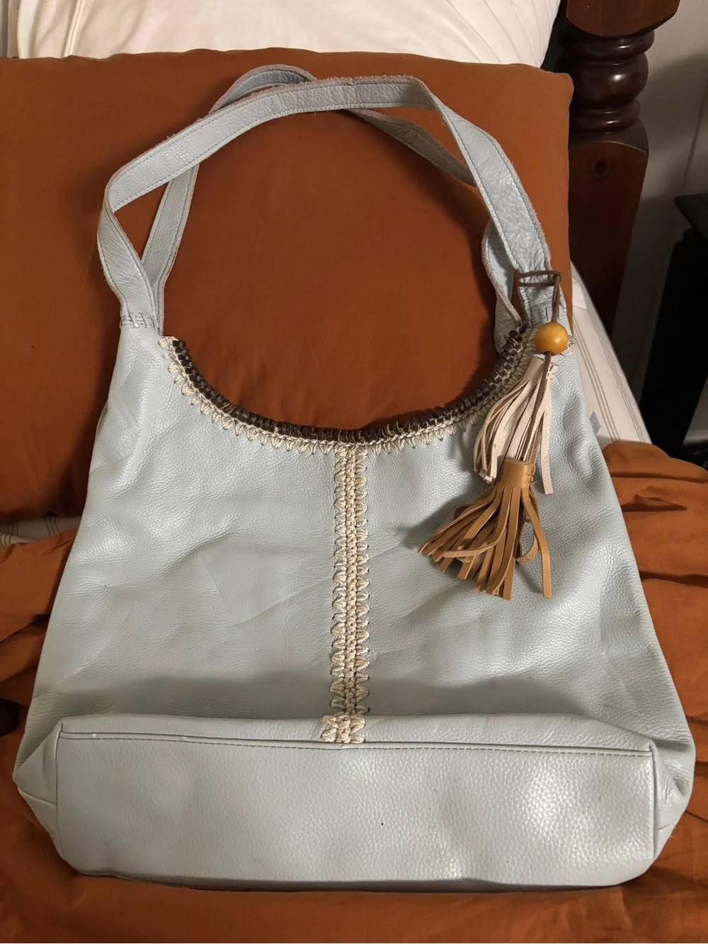 The Sak pale blue leather hobo with tan tassel charm